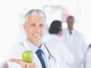 Man holding out an apple